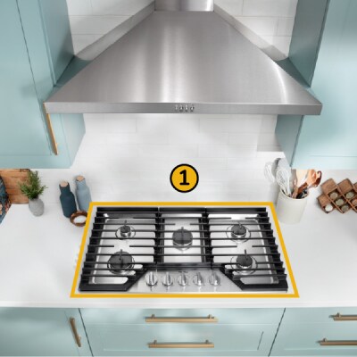 A Whirlpool® Cooktop below a Whirlpool® Range Hood with a number one