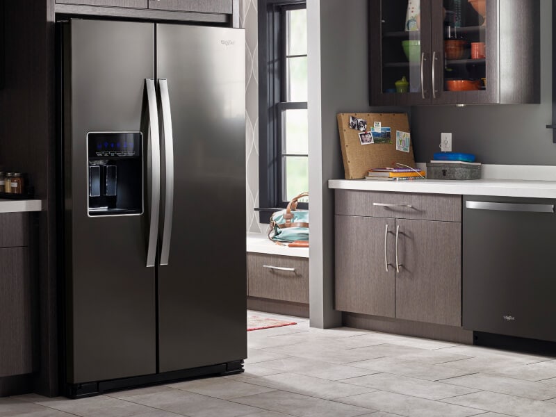 A darker kitchen with a black Whirlpool® Refrigerator and dishwasher A darker kitchen with a black Whirlpool® Refrigerator and dishwasher