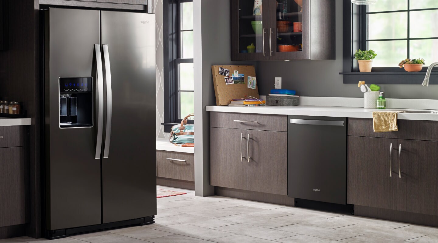 A darker kitchen with a black Whirlpool® Refrigerator and dishwasher A darker kitchen with a black Whirlpool® Refrigerator and dishwasher