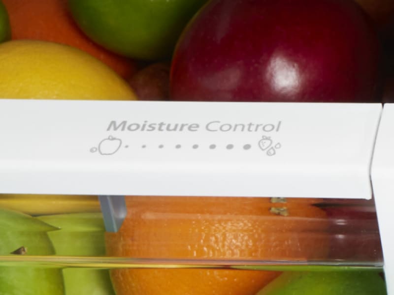 A humidity setting control on a crisper drawer A humidity setting control on a crisper drawer