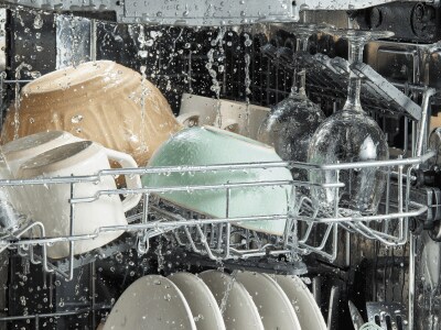 Water spraying on dishes inside a dishwasher
