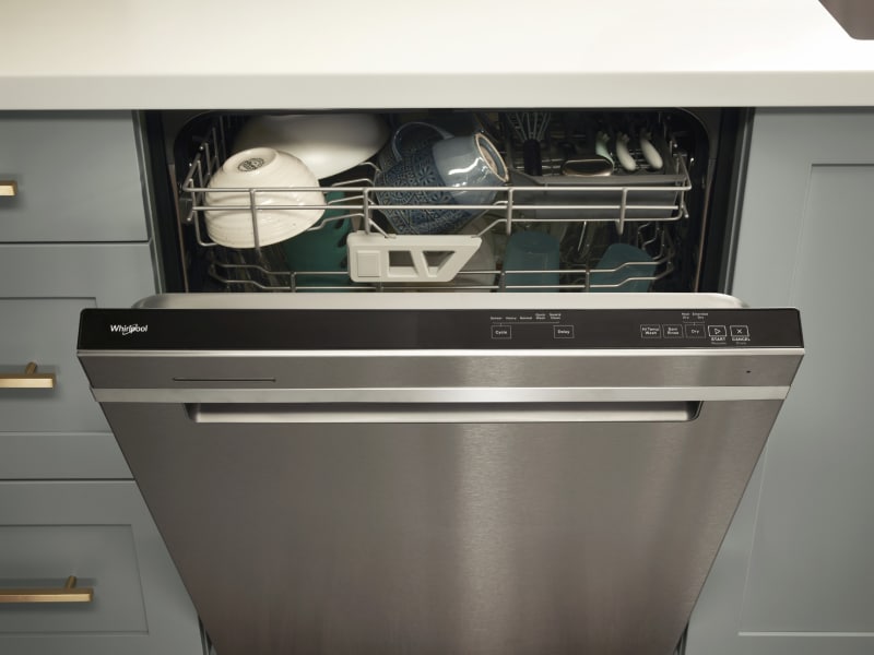A loaded Whirlpool® dishwasher with an open door A loaded Whirlpool® dishwasher with an open door