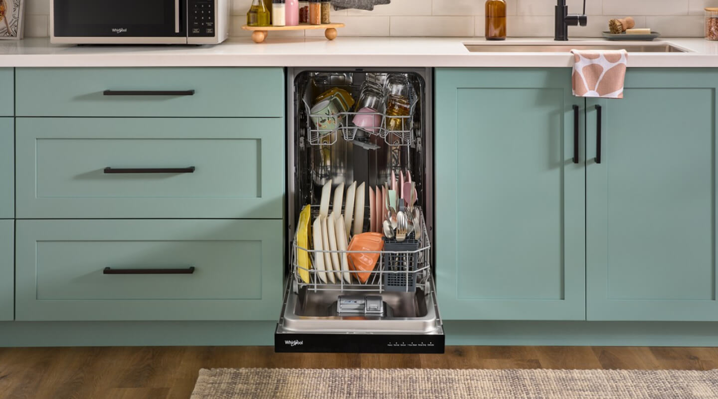 A kitchen with blue cabinetry and a compact dishwasher