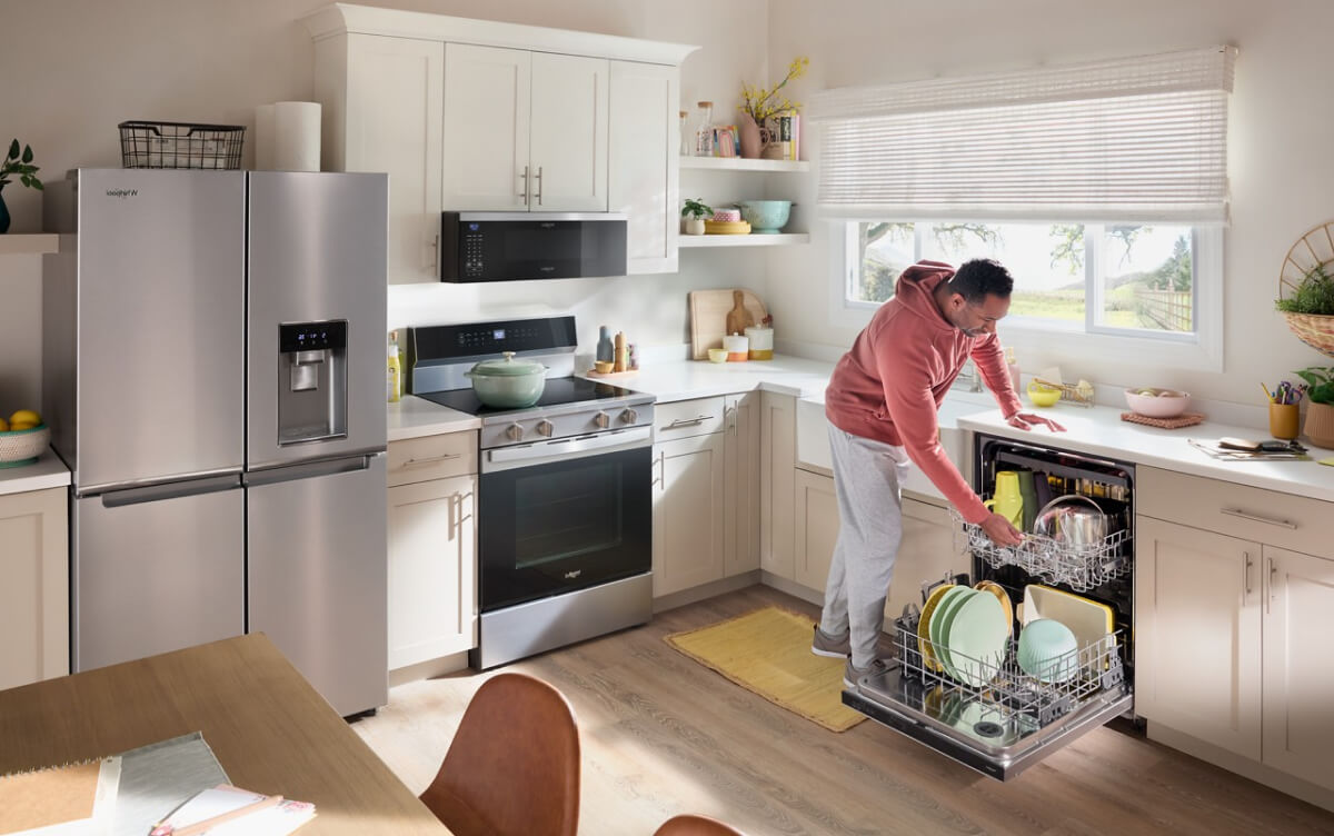 A man unloading his dishwasher
