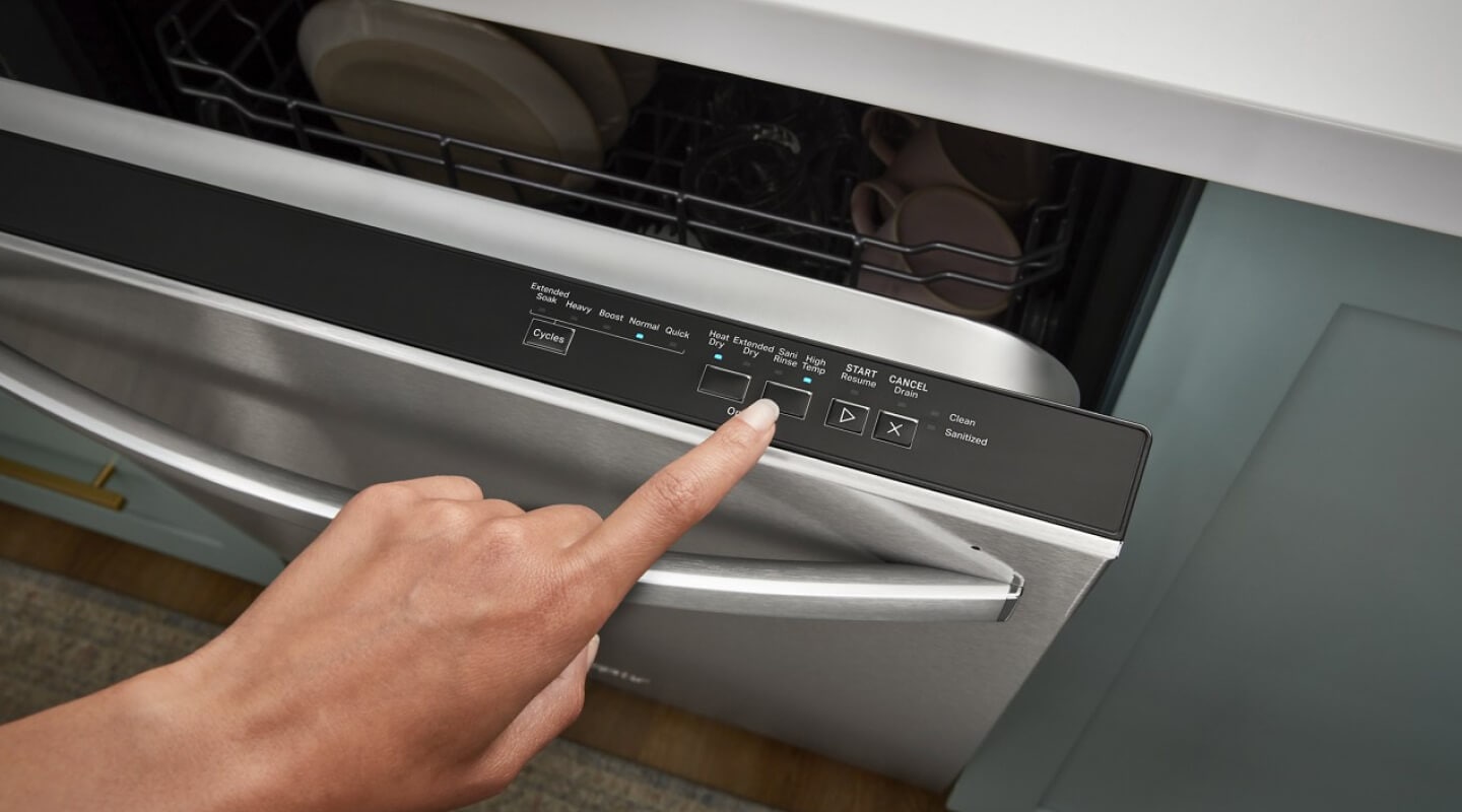 Person selecting a cycle on a dishwasher Person selecting a cycle on a dishwasher