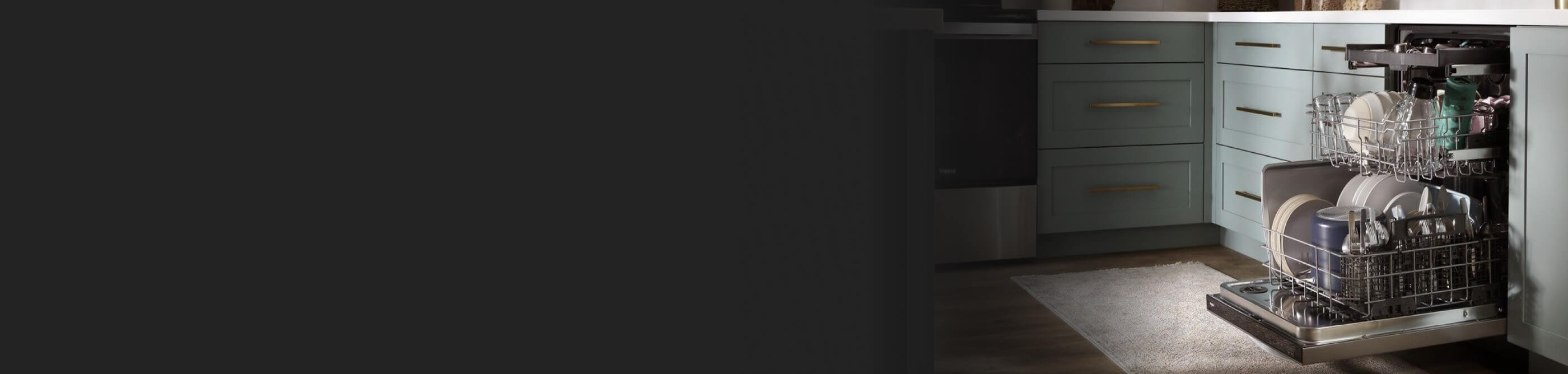 A dishwasher sitting next to teal cabinets in a kitchen