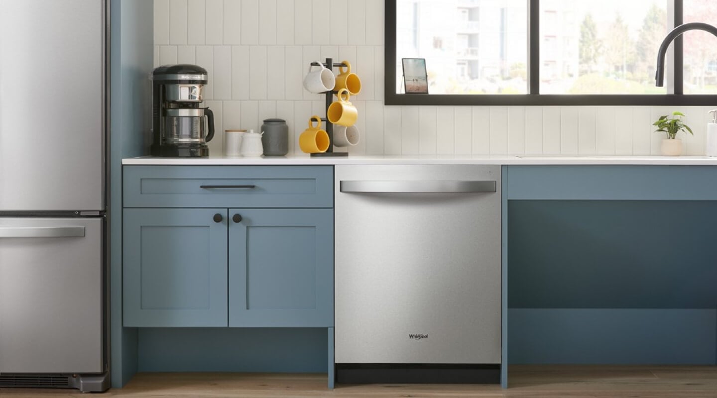 A Whirlpool® Dishwasher in a kitchen with blue cabinets