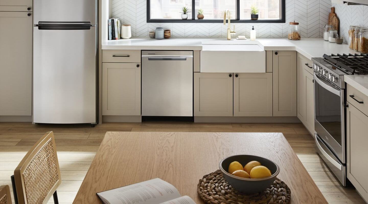 A Whirlpool® Dishwasher in a kitchen with beige cabinets