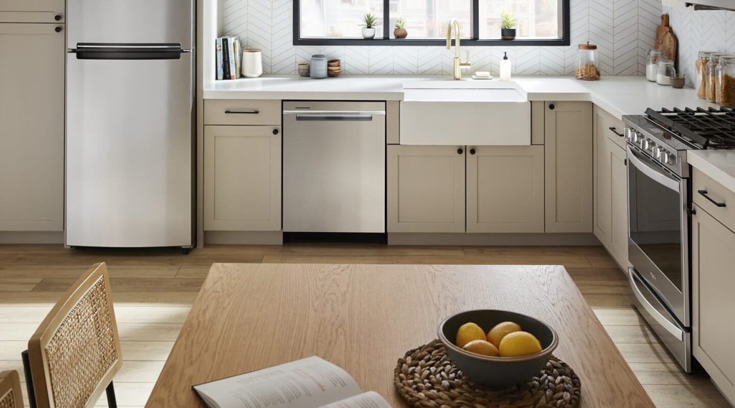 A Whirlpool® Dishwasher in a kitchen with beige cabinets