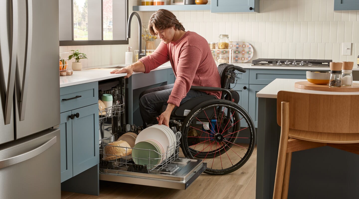 Person unloading an ADA compliant dishwasher
