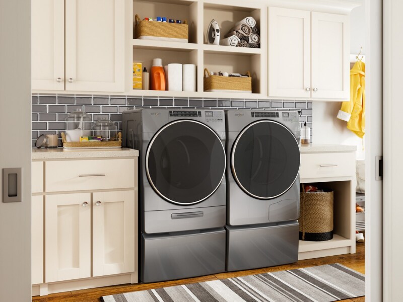 Front load Whirlpool® Washer and Dryer pair on pedestals in a laundry room Front load Whirlpool® Washer and Dryer pair on pedestals in a laundry room
