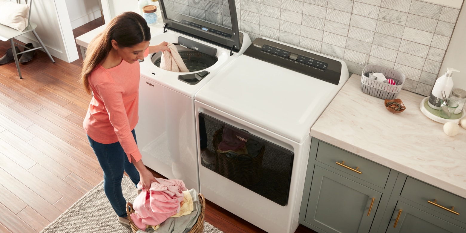 Person loading washer with clothes