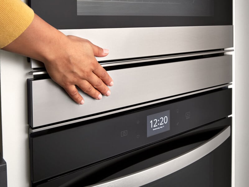 Hand touching a Whirlpool® double wall oven Hand touching a Whirlpool® double wall oven