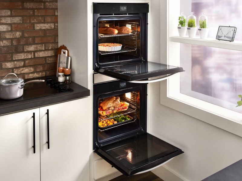 Multiple dishes cooking inside a Whirlpool® double wall oven Multiple dishes cooking inside a Whirlpool® double wall oven