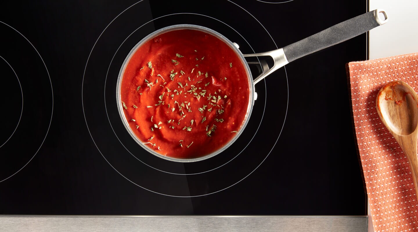 Tomato soup in a saucepan on an electric cooktop Tomato soup in a saucepan on an electric cooktop