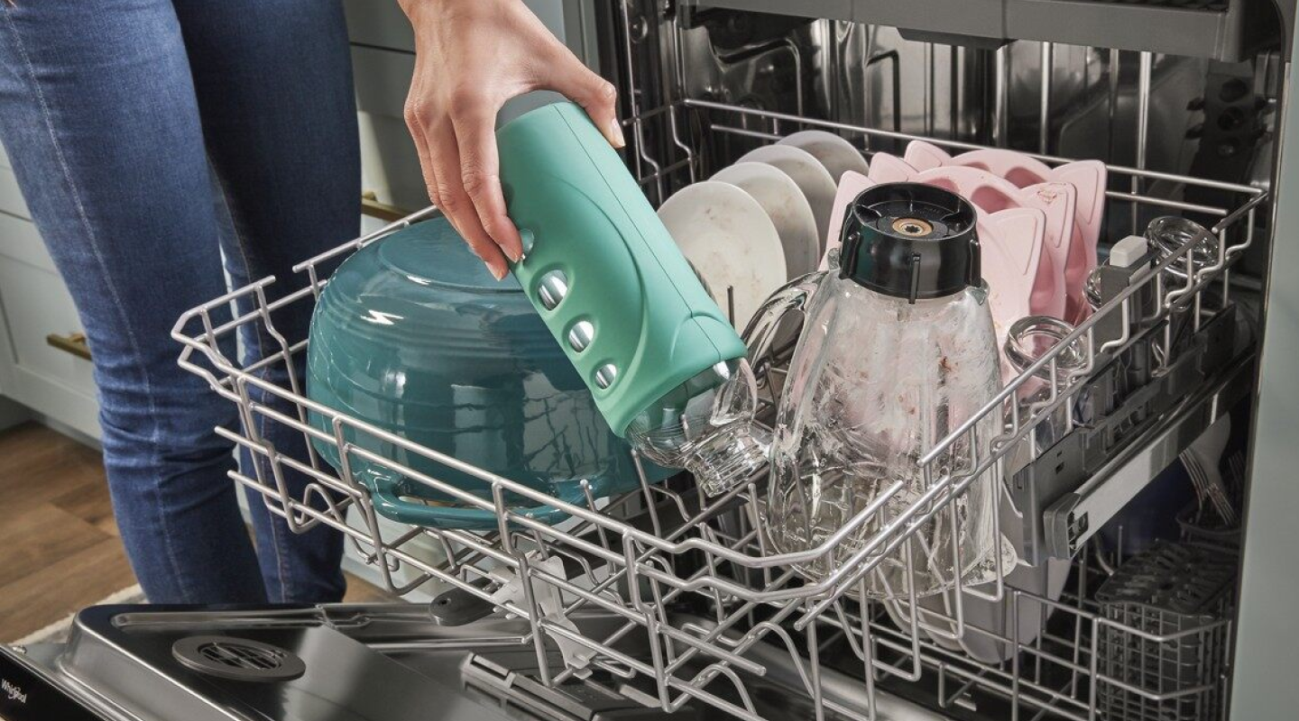 A person unloading a dishwasher A person unloading a dishwasher