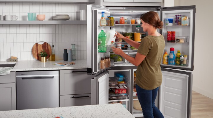 A person placing ingredients in a fridge