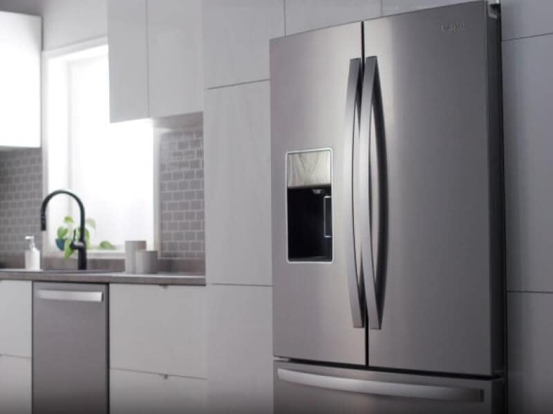 Stainless steel Whirlpool® French door refrigerator in light gray cabinetry