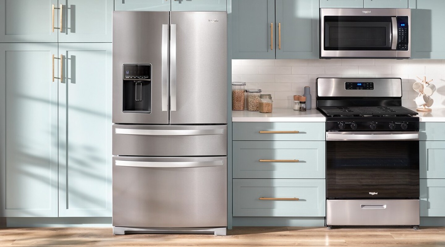 Stainless steel Whirlpool® French Door Refrigerator set in teal cabinetry