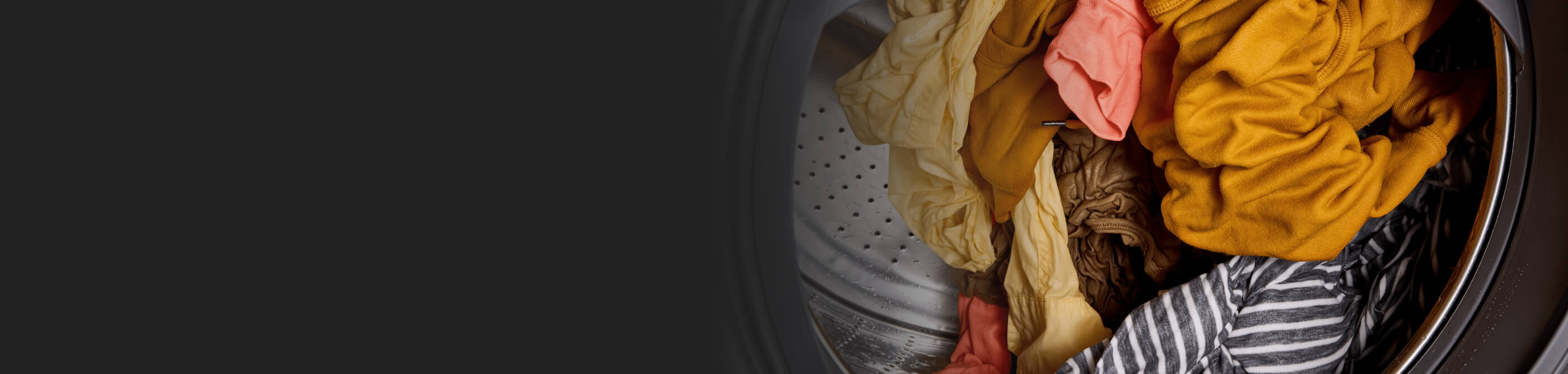 Colored clothes tumbling inside of washer