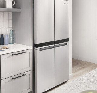 A stainless steel Whirlpool® refrigerator in a kitchen