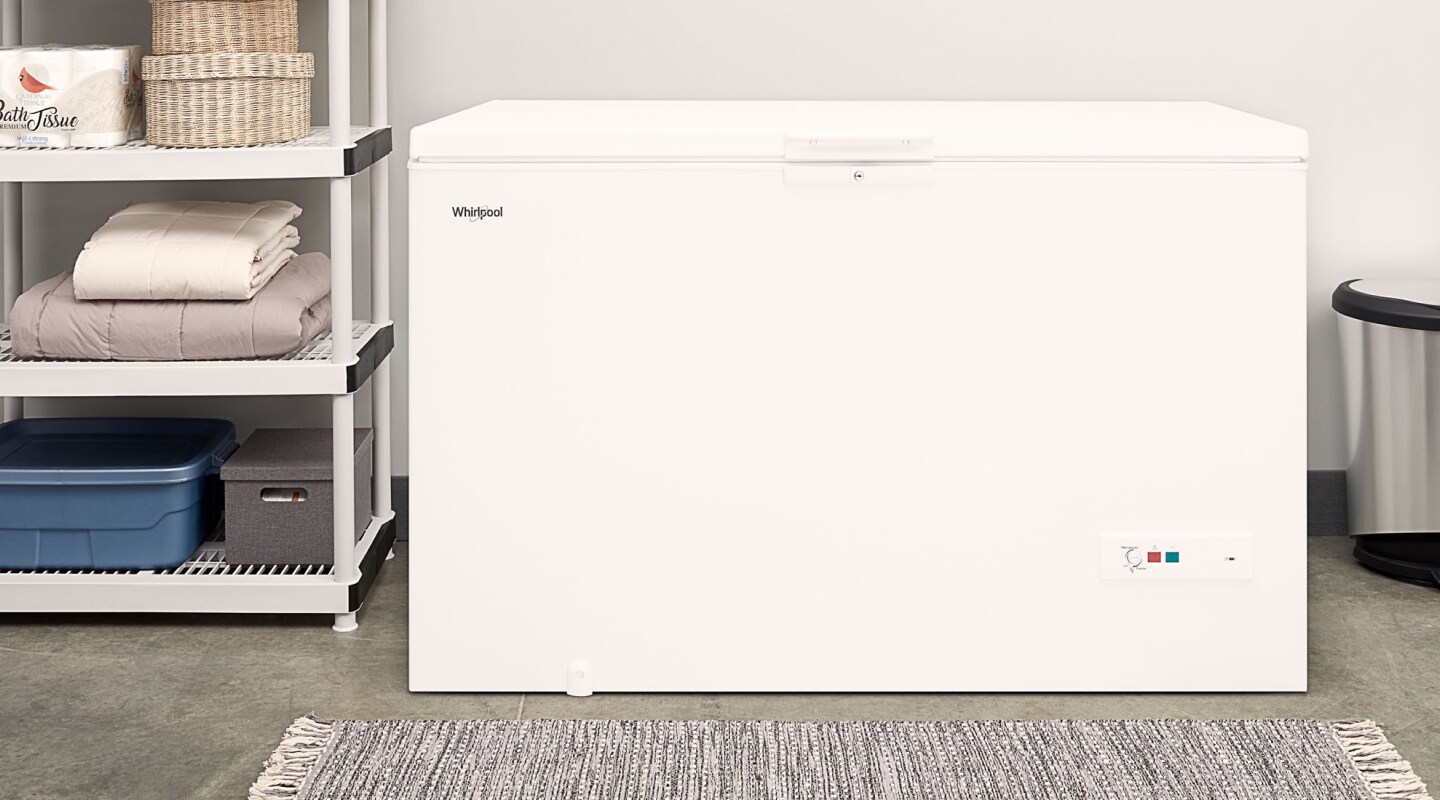 A chest deep freezer in a laundry room A chest deep freezer in a laundry room