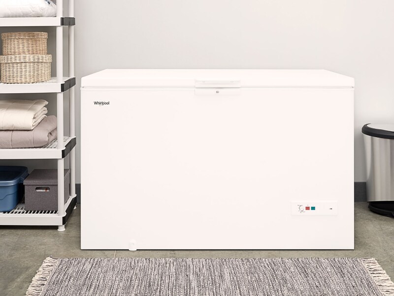 A chest deep freezer in a laundry room A chest deep freezer in a laundry room