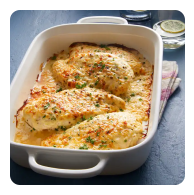 Cheesy baked chicken in a white roasting dish