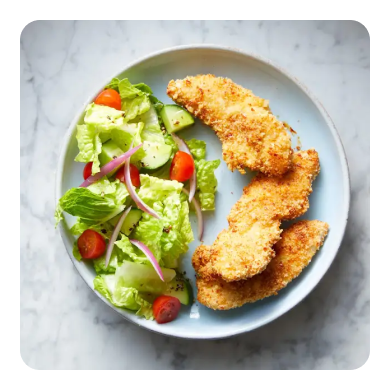 Breaded chicken tenders and salad on a plate Breaded chicken tenders and salad on a plate