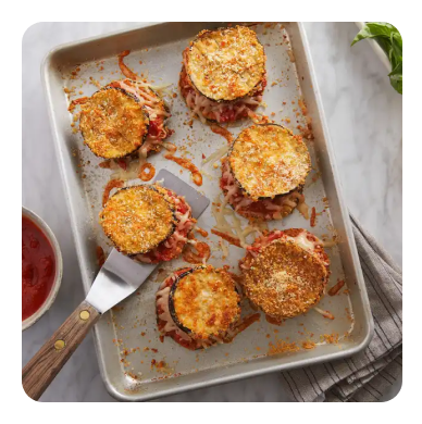 Breaded eggplant on a silver sheet pan Breaded eggplant on a silver sheet pan