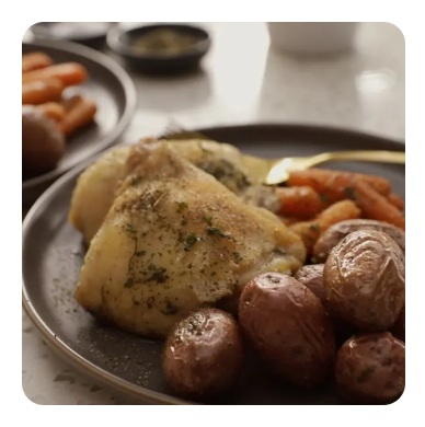 A close-up plate of roasted potatoes, chicken and carrots A close-up plate of roasted potatoes, chicken and carrots