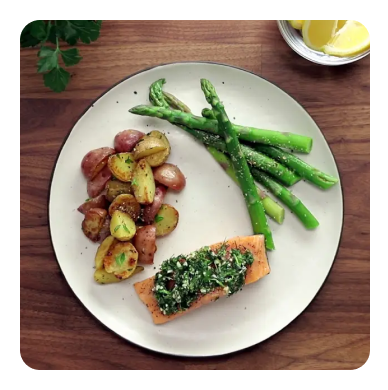 Salmon with asparagus and potatoes on a white plate