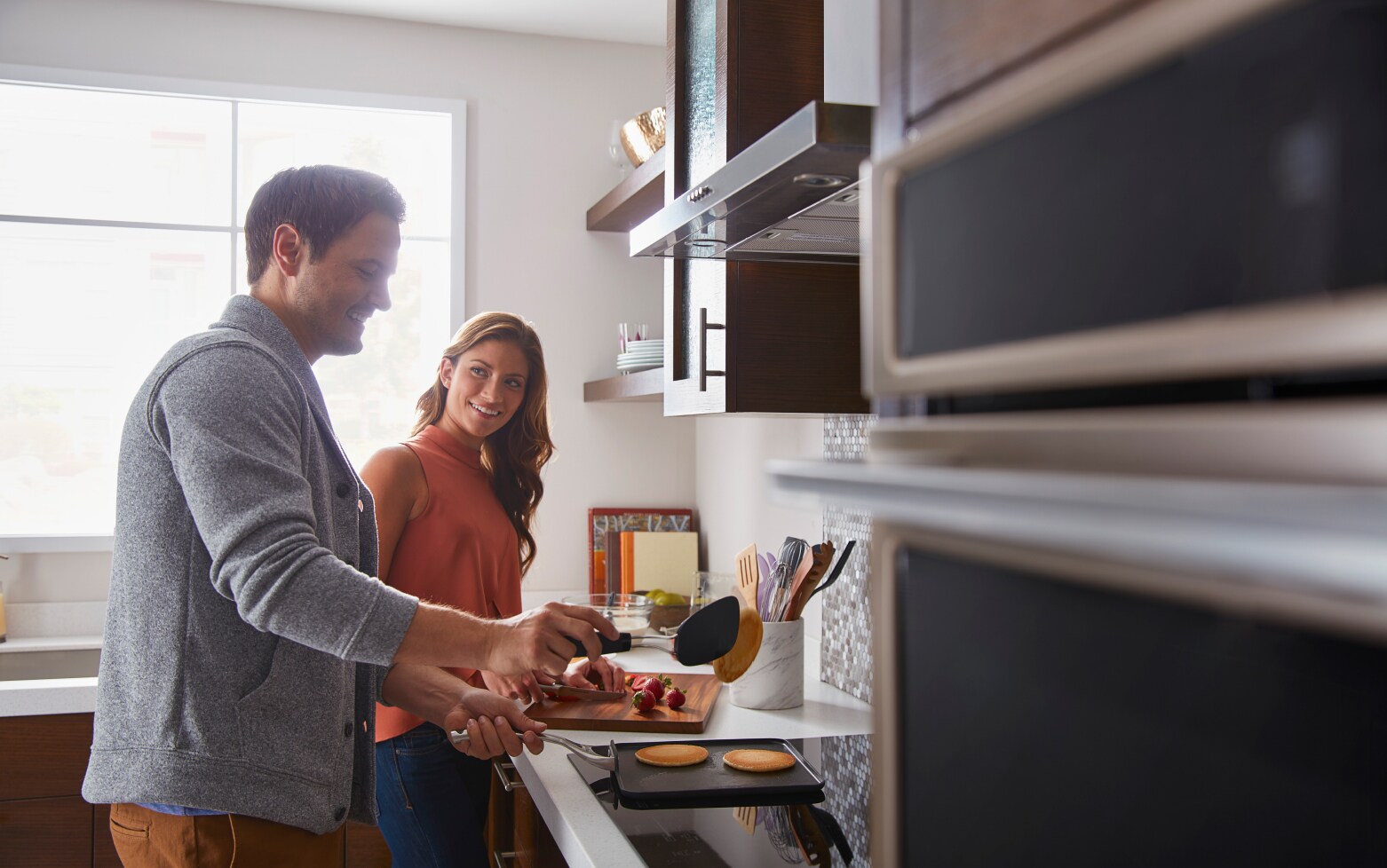 Man and woman preparing food in a kitchen Man and woman preparing food in a kitchen