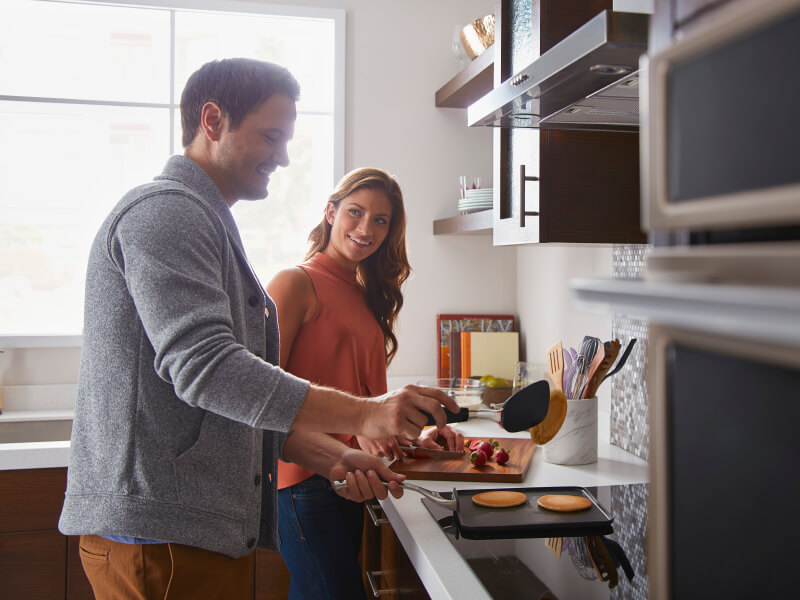 Man and woman preparing food in a kitchen Man and woman preparing food in a kitchen