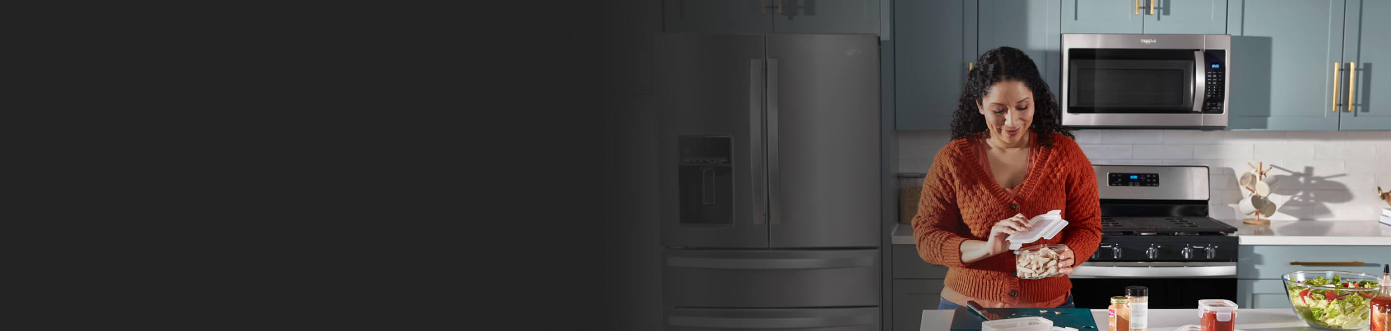 Woman opening a container in her kitchen