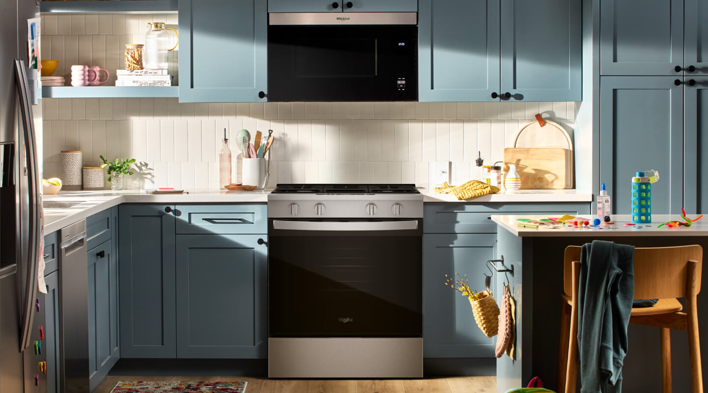 A bright kitchen with blue cabinetry