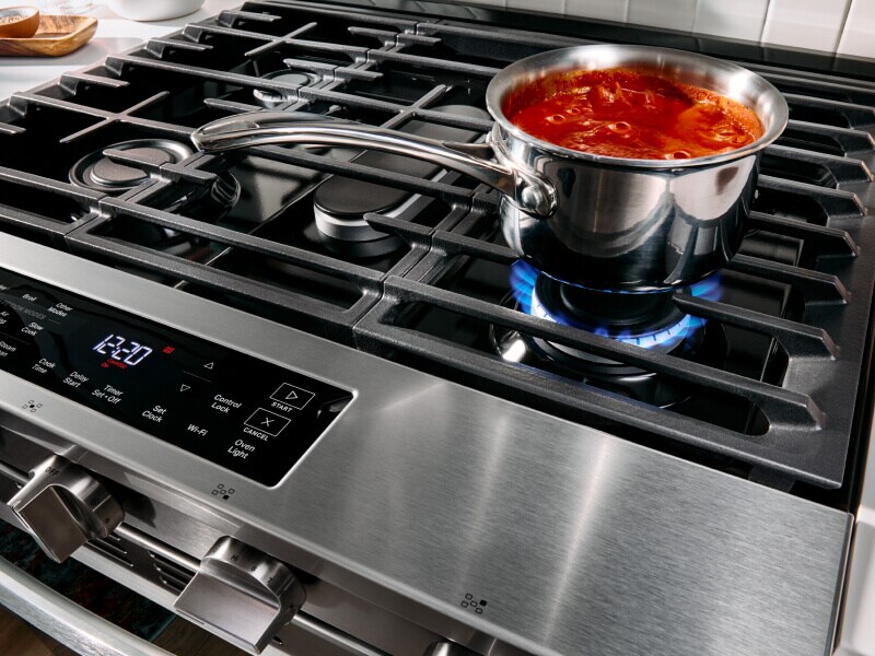 Pasta sauce cooking on top of a gas stove
