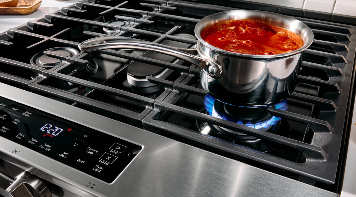 Pasta sauce cooking on top of a gas stove