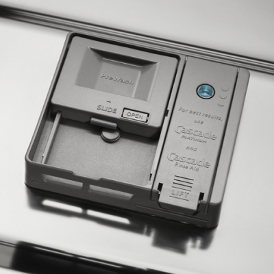 A detergent dispenser of a Whirlpool® dishwasher.