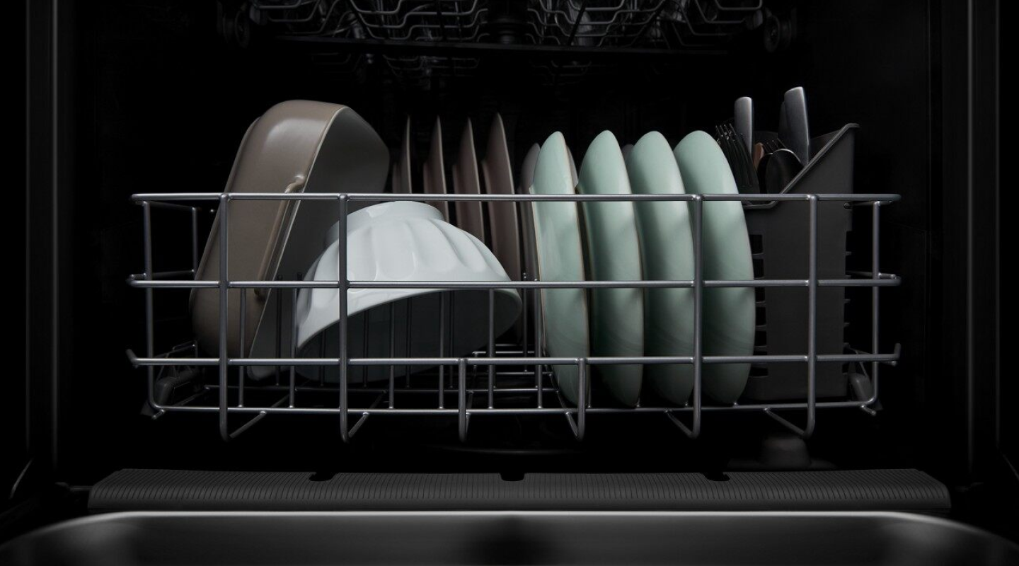 A closeup of the bottom rack of a Whirlpool® dishwasher with clean dishware. A closeup of the bottom rack of a Whirlpool® dishwasher with clean dishware.