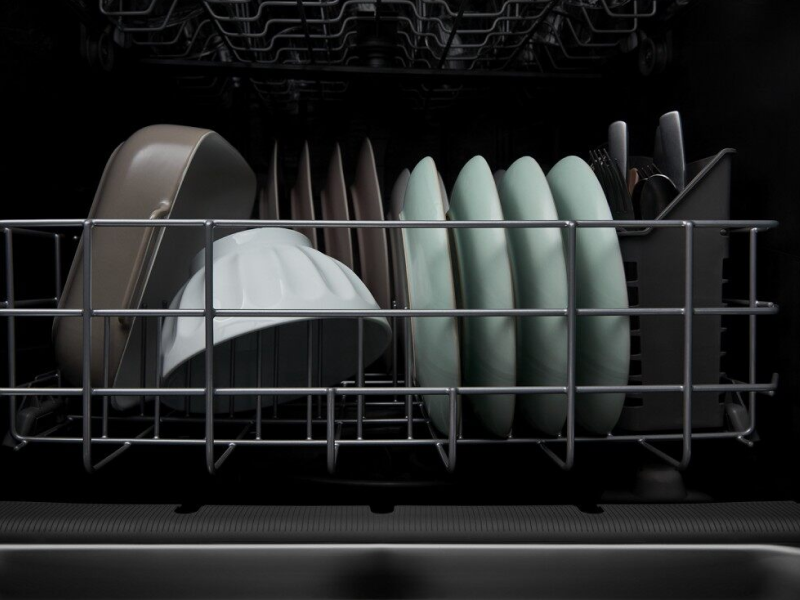 A closeup of the bottom rack of a Whirlpool® dishwasher with clean dishware. A closeup of the bottom rack of a Whirlpool® dishwasher with clean dishware.