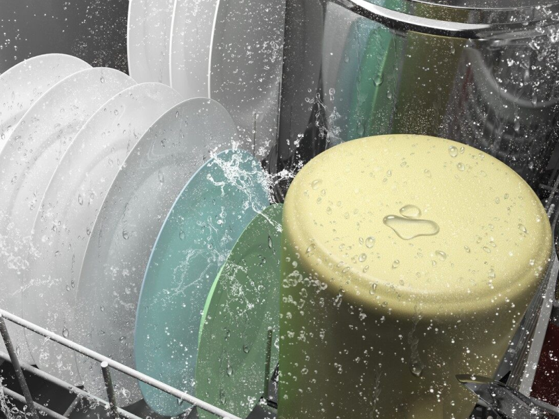 A closeup of the bottom rack of a Whirlpool® dishwasher washing dishware during a wash cycle. A closeup of the bottom rack of a Whirlpool® dishwasher washing dishware during a wash cycle.