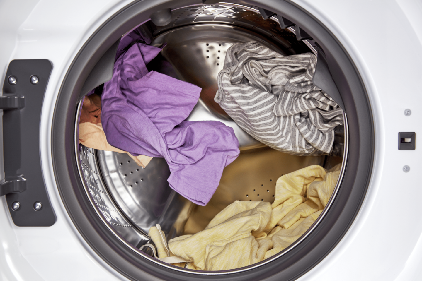 Interior shot of clothes tumbling in a dryer drum. Interior shot of clothes tumbling in a dryer drum.