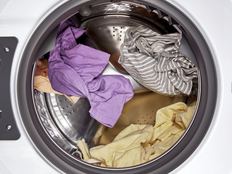 Interior shot of clothes tumbling in a dryer drum. Interior shot of clothes tumbling in a dryer drum.