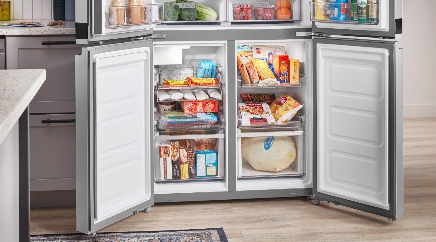 Freezer compartments of a four-door refrigerator full of food Freezer compartments of a four-door refrigerator full of food