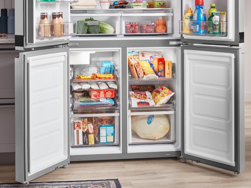 Freezer compartments of a four-door refrigerator full of food Freezer compartments of a four-door refrigerator full of food