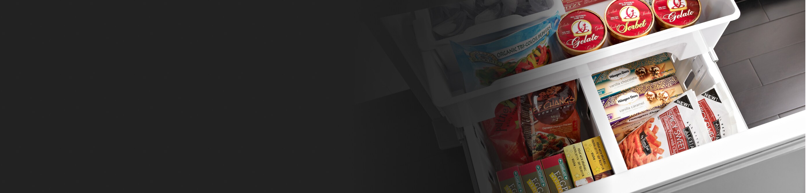 Birds-eye view of French door refrigerator pull-out freezer drawer full of food