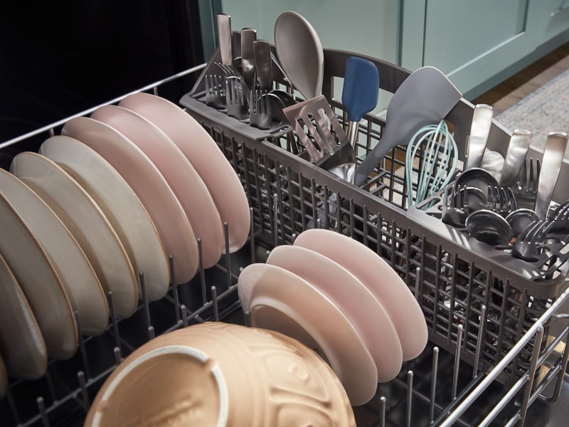 The bottom rack of a Whirlpool® dishwasher filled with dishes. The bottom rack of a Whirlpool® dishwasher filled with dishes.