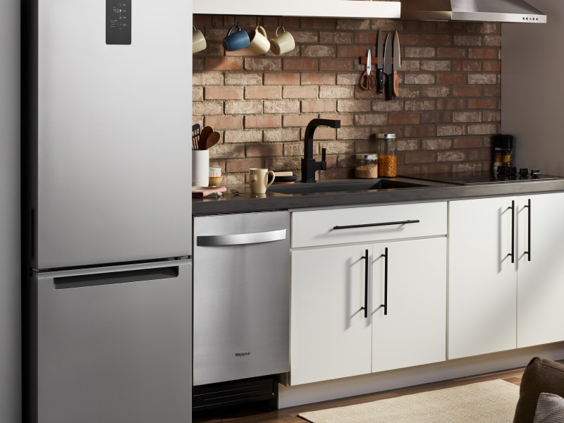 A stainless steel Whirlpool® dishwasher, refrigerator and oven in a modern kitchen. A stainless steel Whirlpool® dishwasher, refrigerator and oven in a modern kitchen.