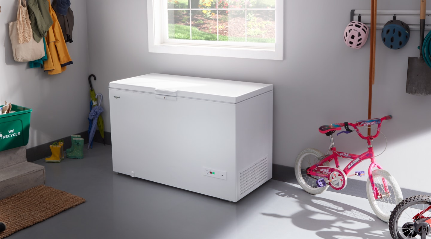 A Whirlpool® Deep freezer in a garage. A Whirlpool® deep freezer in a garage.